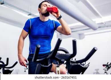 Spinning Instructor At Gym After Class Drinking Water