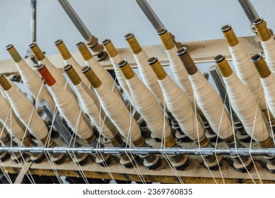 Spinning machinery with spindles close up. - Powered by Shutterstock