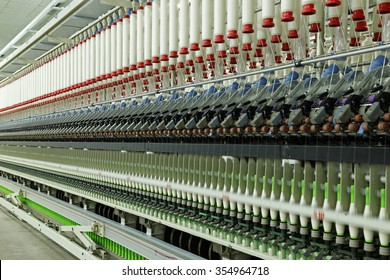 Spinning mill workshop, the workers operating Spinning equipment at work - Powered by Shutterstock