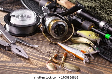 Spinning rods and reels for fishing, on an old background.