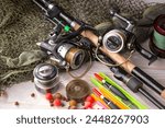 Spinning rods, reels, items for sport fishing, on an old background.