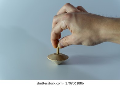 A Spinning Wooden Top On White Background