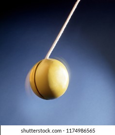 A Spinning Yellow Yoyo Seen From Below.