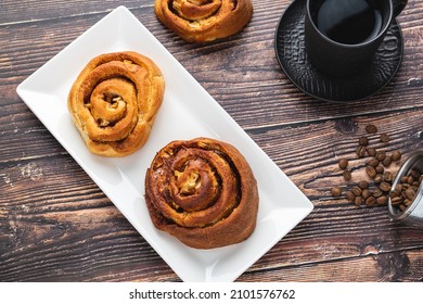 Spiral Apple Cake Or Muffin With Cup Of Fresh Coffee On Wooden Background