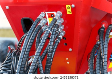 Spiral cable connecting truck cabin and trailer. Pneumatic hoses and electric cables on the coupler of the hitch between a tractor truck and its semi-trailer. Hydraulic control system in new cars. - Powered by Shutterstock