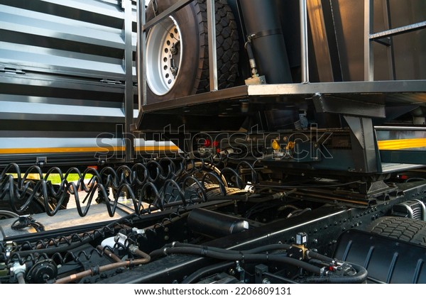 Spiral cable connecting truck cabin and trailer.
Pneumatic hoses and electric cables on the coupler of the hitch
between a tractor truck and its semi-trailer. Hydraulic control
system in new cars.