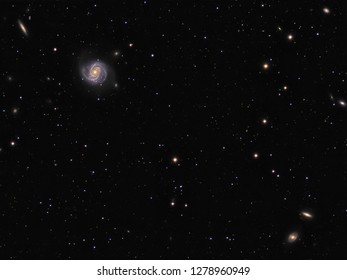 Spiral galaxy M100 (Messier 100) with surrounding galaxies NGC 4312, NGC 4340, NGC 4350 in constellation Coma Berenicus