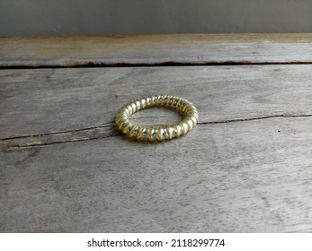 A Spiral Hair Tie On A Wooden Desk