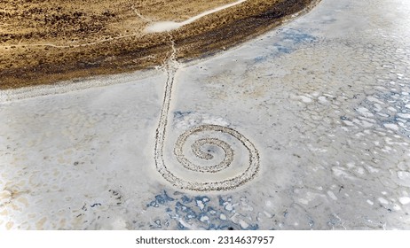 Spiral Jetty on the Great Salt Lake in Utah.  Only visible when water levels are low enough and the 20 year drought has seen the Great Salt Lake recede dramatically, revealing the Spiral Jetty.