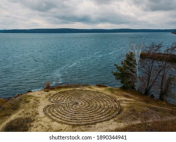 Spiral labyrinth made of stones on the coast, aerial view .
