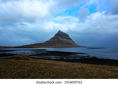 Spiral mountian (Kirkjufell) from a distance over the flat plains
