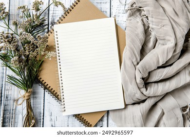 Spiral notebook mockup, blank note journal, wildflowers on wooden background, boho style