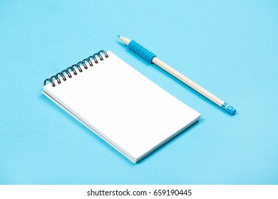 Spiral Notepad With Pencil As Mockup For Your Design. Note Book On Pastel Blue Background.