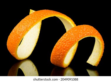 Spiral Orange Zest On A Black Background. Citrus Twist Peel. Citrus Fruit.