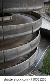 Spiral Parking Garage Entrance With Cork Screw Shaped Ramp Made Of Concrete, Above An Access Road