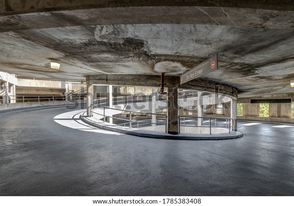 A spiral ramp\
in a concrete parking garage.