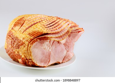 Spiral Sliced Pork Ham Isolated On White Background. Holiday Food.