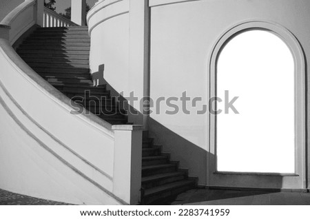 Spiral staircase in castle, upward stairs in palace or tower with arched white mockup window. concrete wall. medieval architecture design, empty building exterior. mock up. 