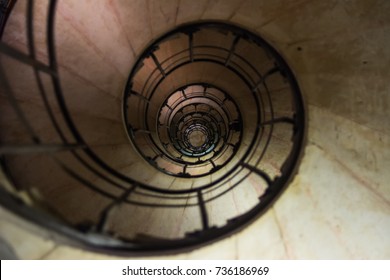 Spiral Staircase : Interior design of spiral stair case. Upside view of indoor spiral winding staircase with black metal ornamental handrail. Architectural detail 