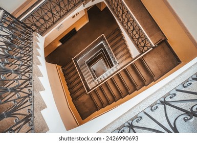 Spiral staircase, intricate railings, descending perspective, warm tones. - Powered by Shutterstock