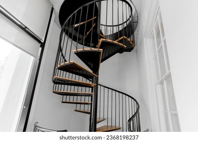 Spiral Staircase Modern Black and Wood Steps with White Interior and Track Lighting - Powered by Shutterstock