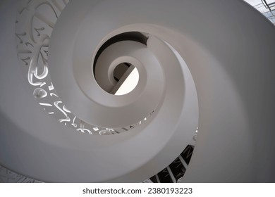 Spiral staircase shot from the bottom, looking up. Museum of the future in Dubai, United Arab Emirates. - Powered by Shutterstock