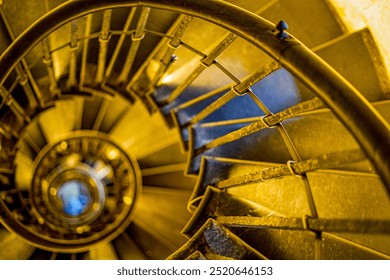 Spiral staircase that emits golden light - Powered by Shutterstock