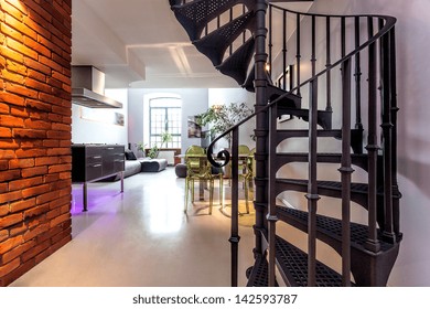 Spiral Stairs And Living Room In Modern Loft