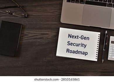 Spiral-bound notebook displaying 'Next-Gen Security Roadmap' on a professional workspace surrounded by business tools. Perfect eyecatcher for cybersecurity strategy articles and IT security blog posts.
