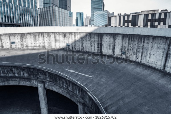 Spiraling concrete ramps of a large parking\
garage in Shanghai