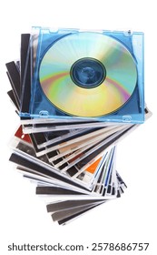 Spiraling stack of music CDs. Blank CD on top with a rainbow reflection.