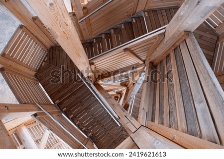 Spiraling wooden tower stairs. Top view, no people.