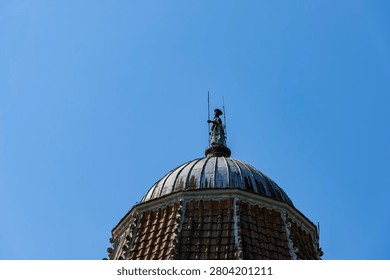 Spire featuring a bronze statue of John the Baptist,Baptistery of San Giovanni, the Cathedral's baptismal church on Piazza del Duomo – the Cathedral Square, unofficially known as Piazza dei Miracoli – in Pisa, Tuscany, Italy.