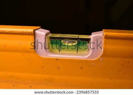 spirit level ruler yellow precision bubble close up. High quality photo