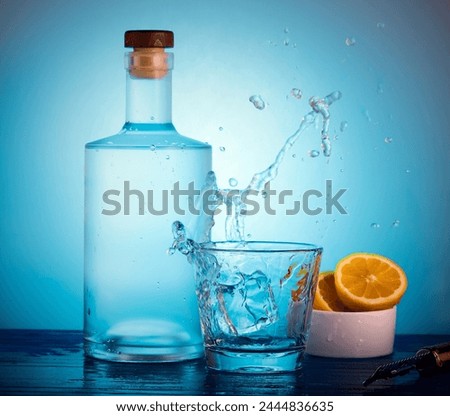 Spirits bottle and a glass with a splash coming out of glass.