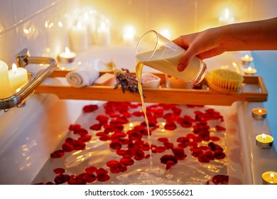 Spiritual aura cleansing flower bath for full moon ritual with coconut milk, candles, aroma salt, lavender and rose petals. Body care and mental health routine. - Powered by Shutterstock