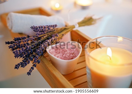 Spiritual aura cleansing ritual bath for full moon ritual. Candles, aroma salt and lavender on tub table, close up Foto d'archivio © 