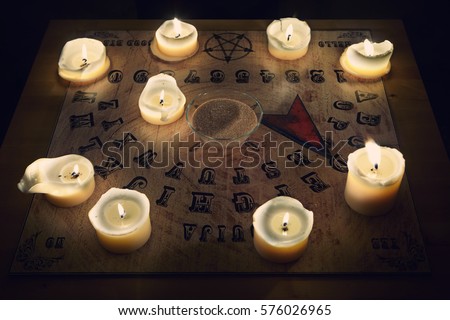 Spiritual board ouija with candles