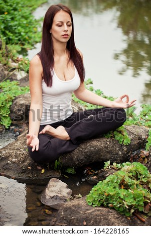 Similar – Young woman doing yoga in nature