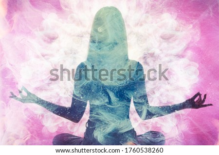 Spiritual practice. Harmony balance. Meditating woman silhouette in pink ethereal smoke double exposition.