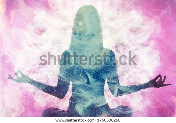 Spiritual practice.\
Harmony balance. Meditating woman silhouette in pink ethereal smoke\
double exposition.