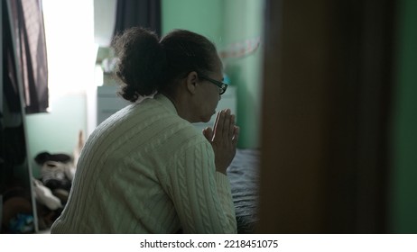 Spiritual Senior Latin Woman Praying To God At Home