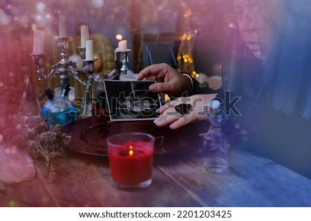 spiritualistic seance in salon of medium with old photographs, Female Fortuneteller, esoteric Oracle, longing for ancestors, communication with spirits, Family Ritual Scripts, crown of celibacy