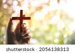 Spirituality and Religion Concept, Person Holding Christian Cross to Making Pray Outdoors. Believe and Faith for Christian People