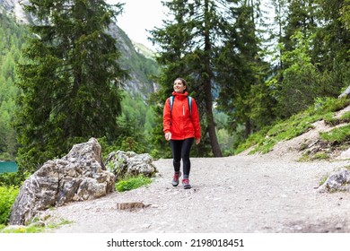 Spiritually Strong Woman Hiking Alone In The Mountains In Red Raincoat