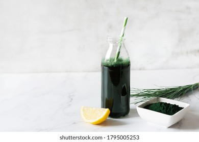 Spirulina Drink With Lemon And Spirulina Algae Powder On White Marble Table. Superfood, Detox Drink.