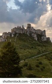 Spis Castle ruins under dramatic evening clouds