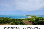 A spit of land extends into the ocean and creates a beautiful blue bay at Dry Tortugas National Park in Florida, as seen from Fort Jefferson.