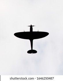 Spitfire Silhouette Against Cloudy Sky