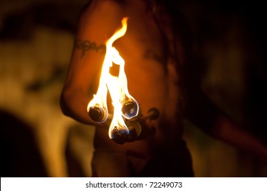 Spitting fire with torch in hand, man
